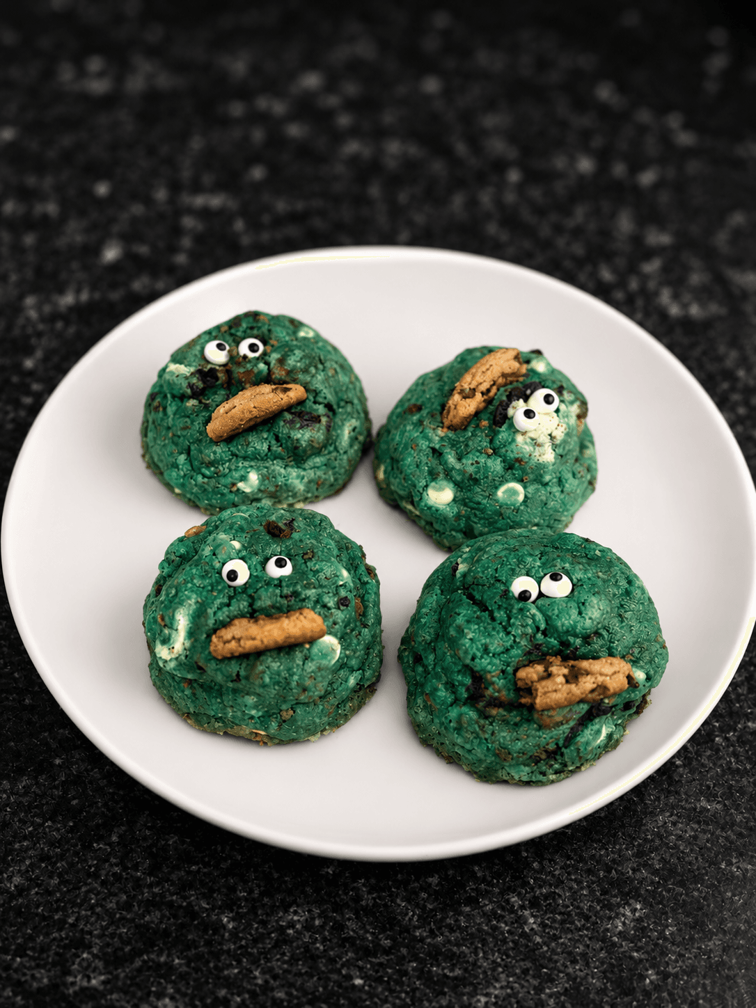 Blue cookie monster cookies with candy eyes and cookie pieces